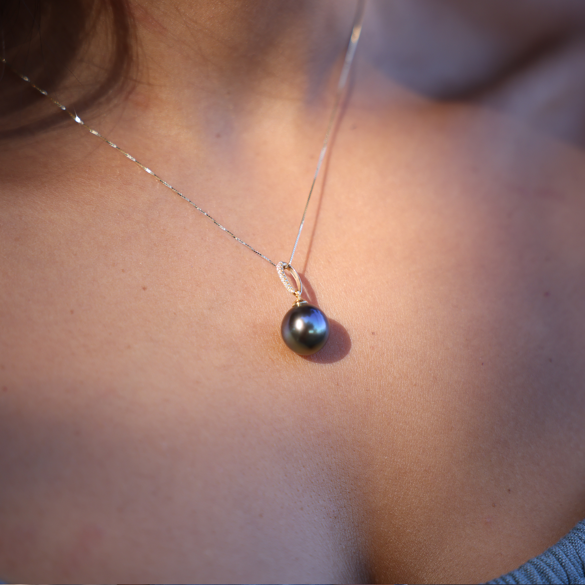 Tahitian Black Pearl Pendant in Gold with Diamonds on Womanʻs Chest - Maui Divers Jewelry
