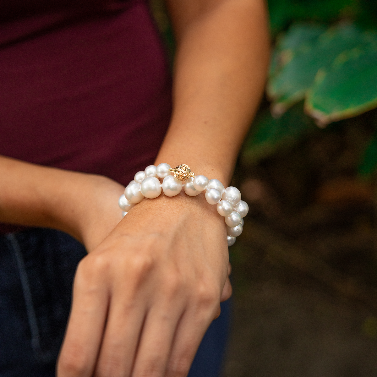 South Sea White Pearl Strand with Magnetic Clasp in Gold wrapped twice around a woman's wrist
