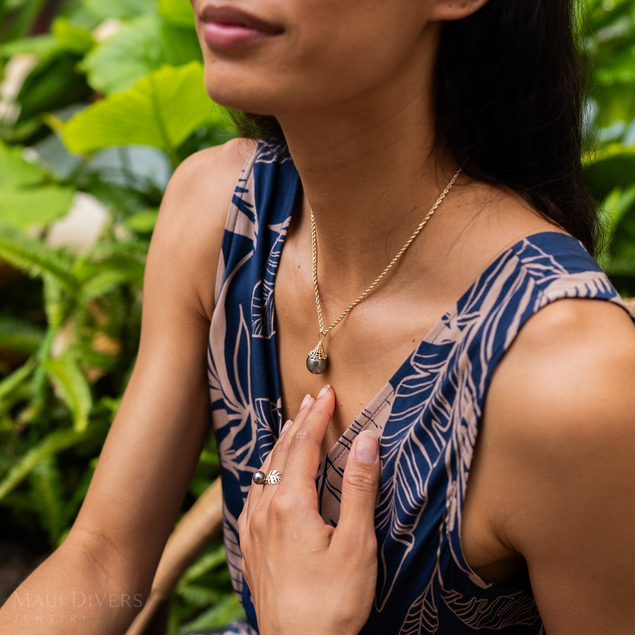 Fish Net 14-17mm Tahitian Black Pearl Pendant in Gold on a woman in a garden