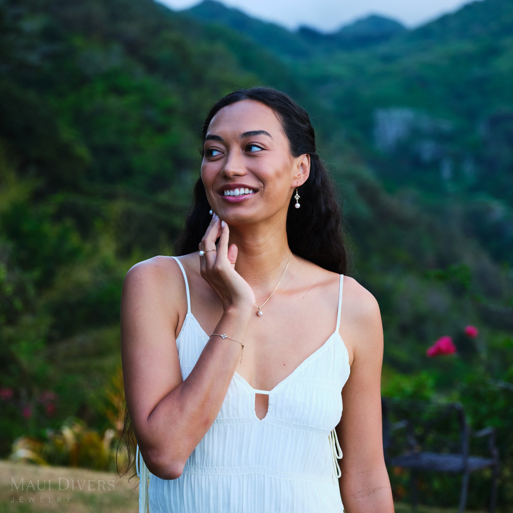 Woman in a white dress standing in a lush green setting wearing Hawaiian Quilted Star Bracelet, Earrings, Pendant and Ring