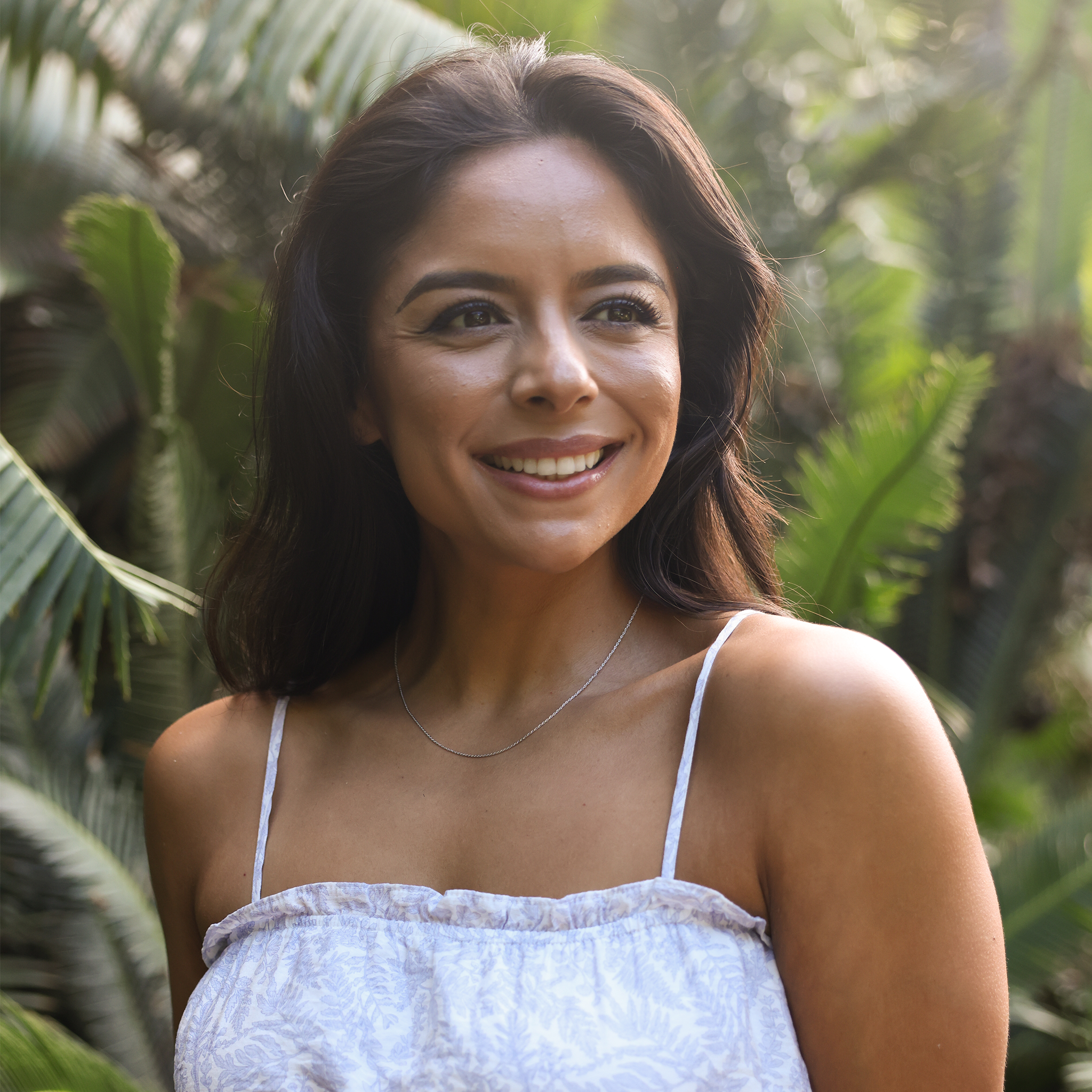 Woman in a tropical garden wearing 1.0mm Rope Chain in 14k White Gold