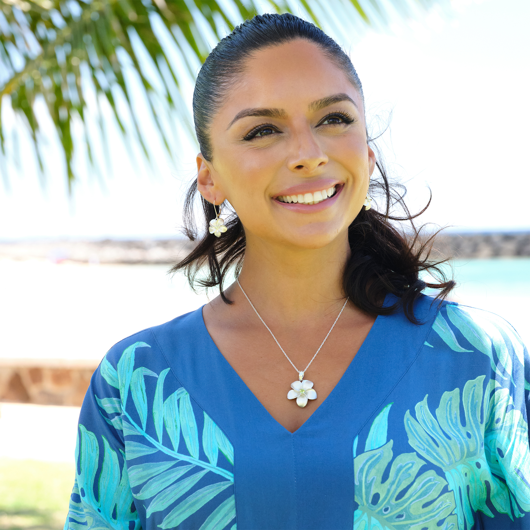 A woman wearing a Plumeria Earrings with Peridot in Sterling Silver - 18mm-Maui Divers Jewelry