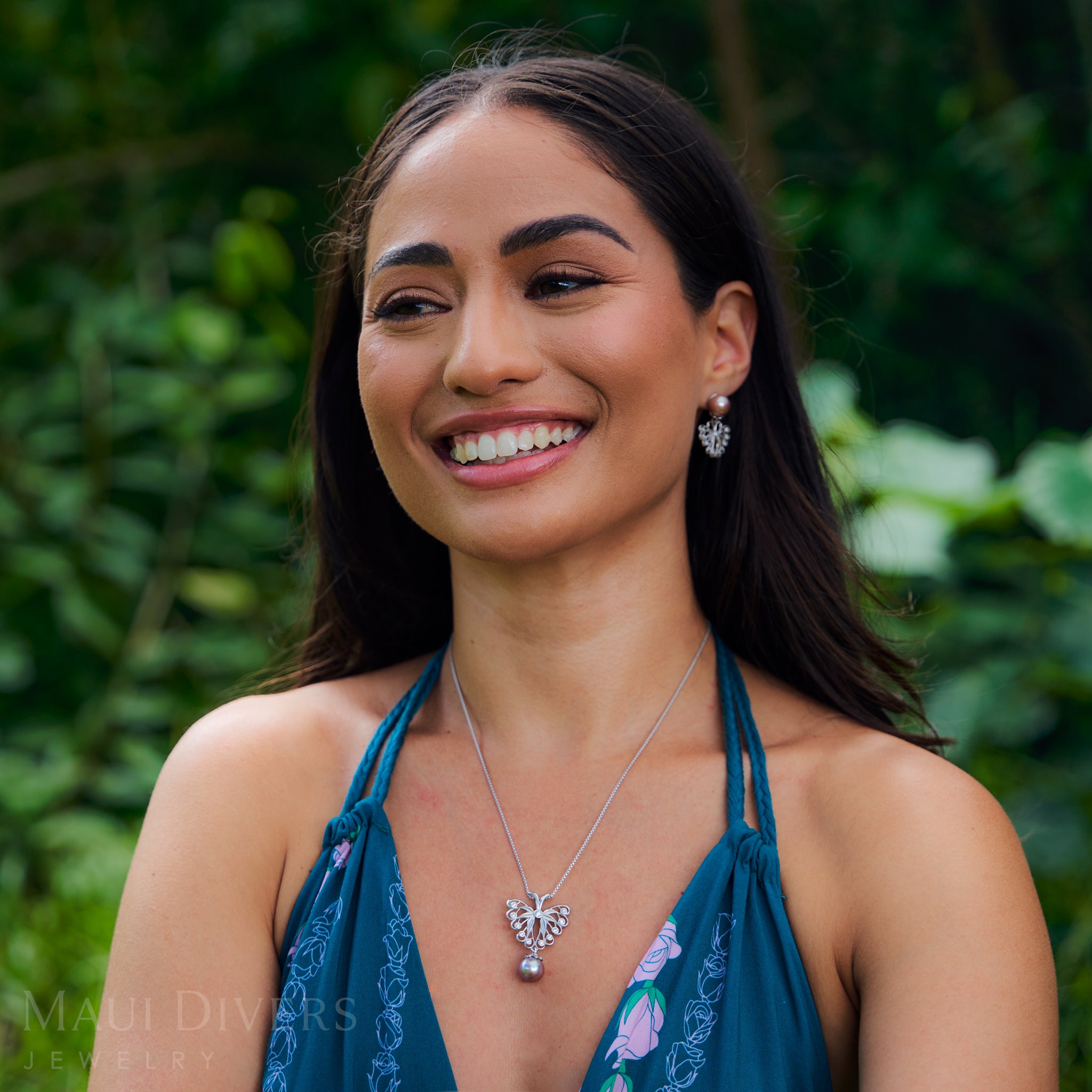 Woman in a garden wearing Butterfly Earring and pendant in Sterling Silver with Cubic Zirconia & Pearls
