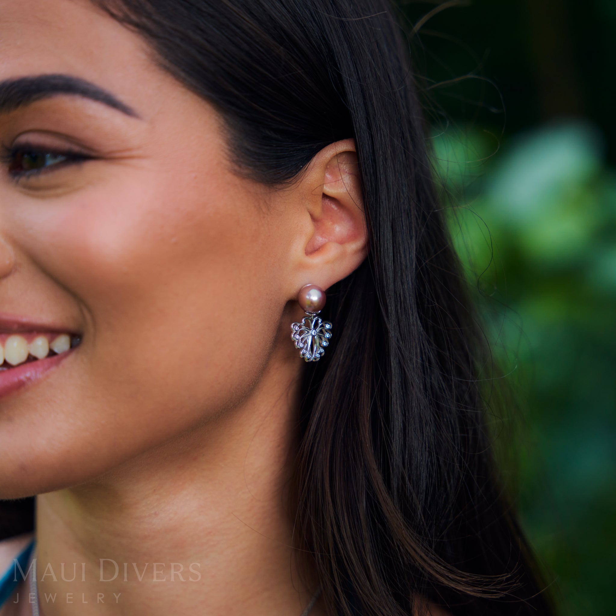 Close-up of a woman wearing Butterfly Earrings in Sterling Silver with Cubic Zirconia & Pearls outdoors