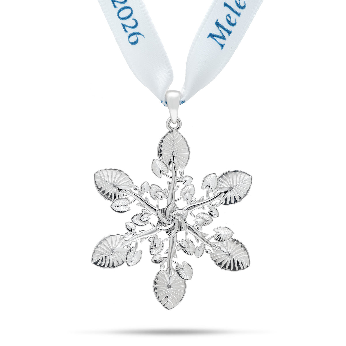 A sterling silver kalo leaf ornament/pendant in a snowflake style formation hanging on a white silk ribbon with 2026 blue lettering, shown on a white background