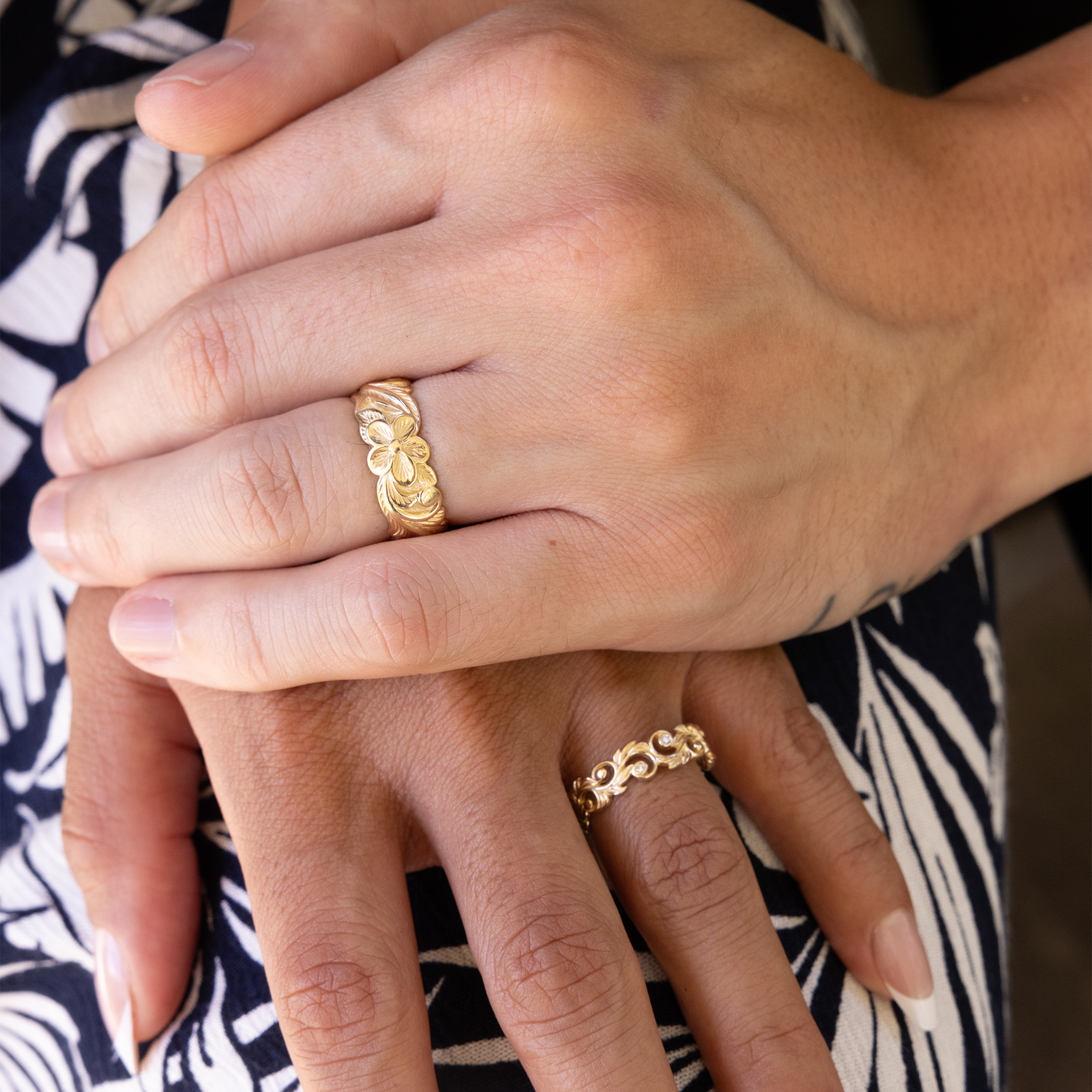 Couple's hands wearing Hawaiian Heirloom Plumeria & Living Heirloom Ring in 14k Yellow Gold with Diamonds