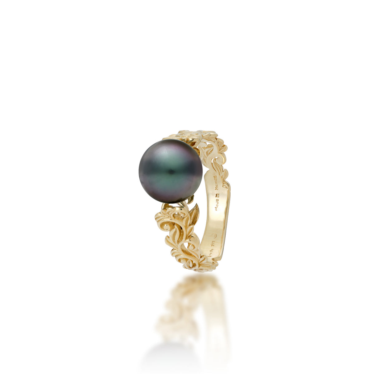 Angle view of a 14k Yellow Gold Living Heirloom Ring with intricate hāpuʻu fern and maile leaf scrollwork and Tahitian black pearl at the crown, shown on a white background