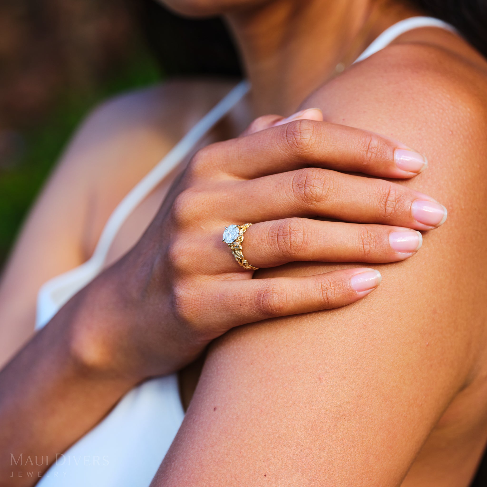 Hand on a shoulder wearing Living Heirloom Engagement Ring in Gold with Diamonds