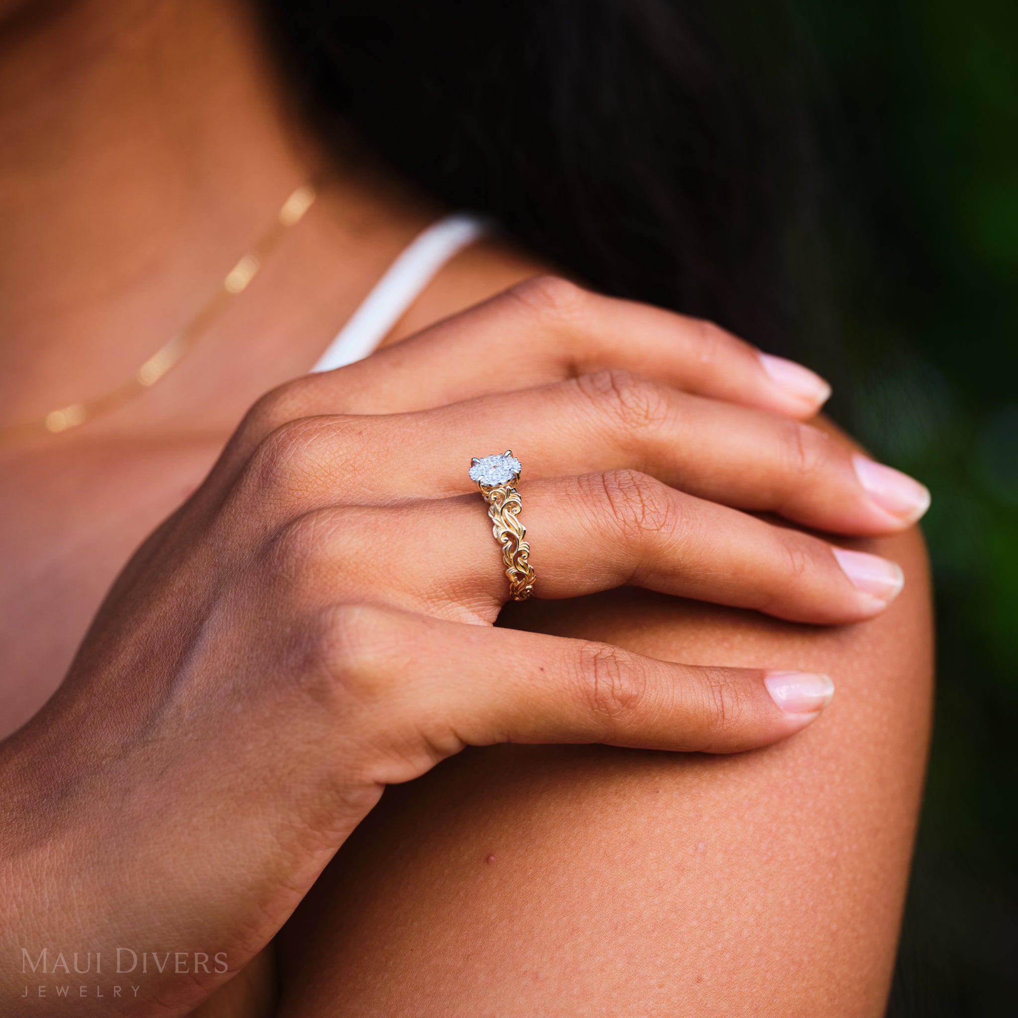 Hand on a shoulder wearing Living Heirloom Engagement Ring in Gold with Diamonds