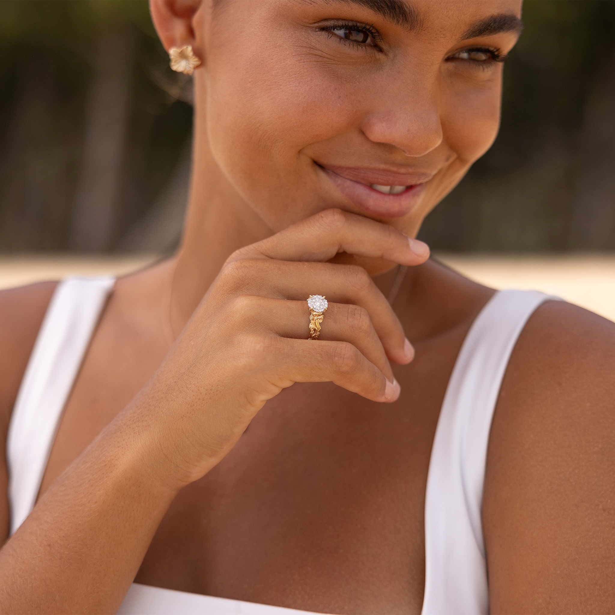 Smiling woman wearing Living Heirloom Engagement Ring in Gold with Diamonds at the beach