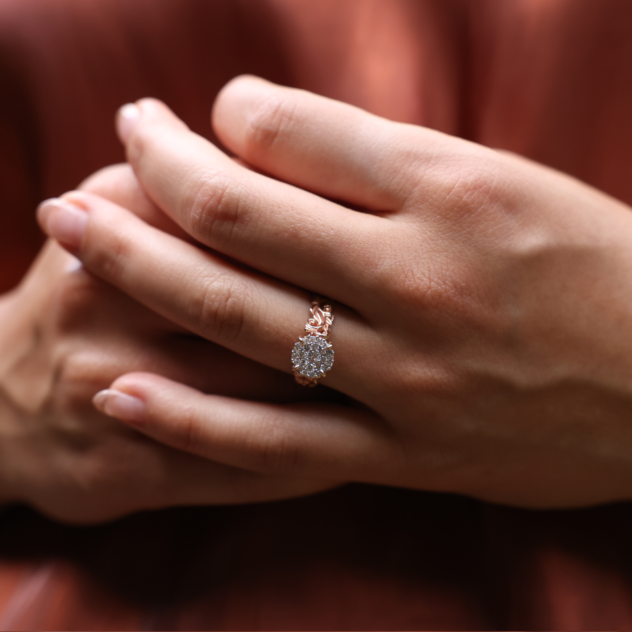 Close up of Living Heirloom Engagement Ring in Rose Gold with Diamonds on a woman's hand