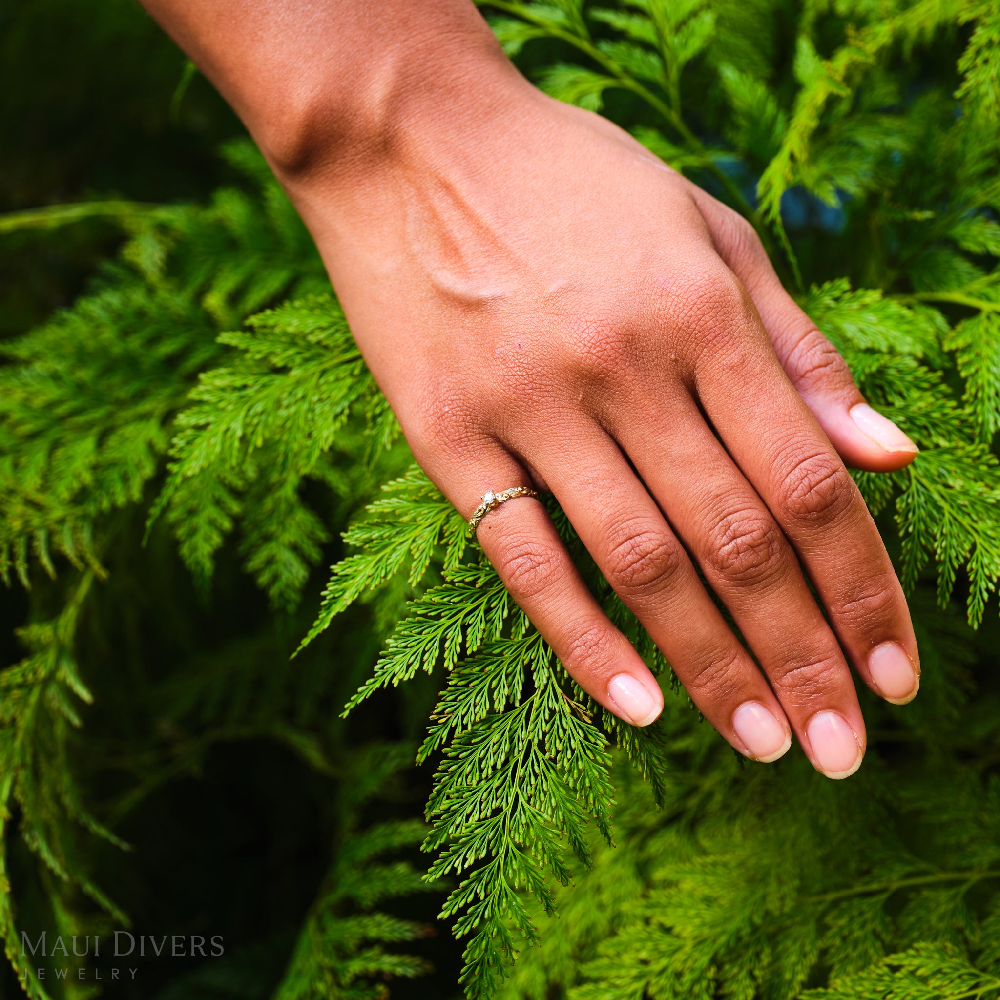 Hand with a Living Heirloom Ring in 14k Yellow Gold with Diamond on a fern background