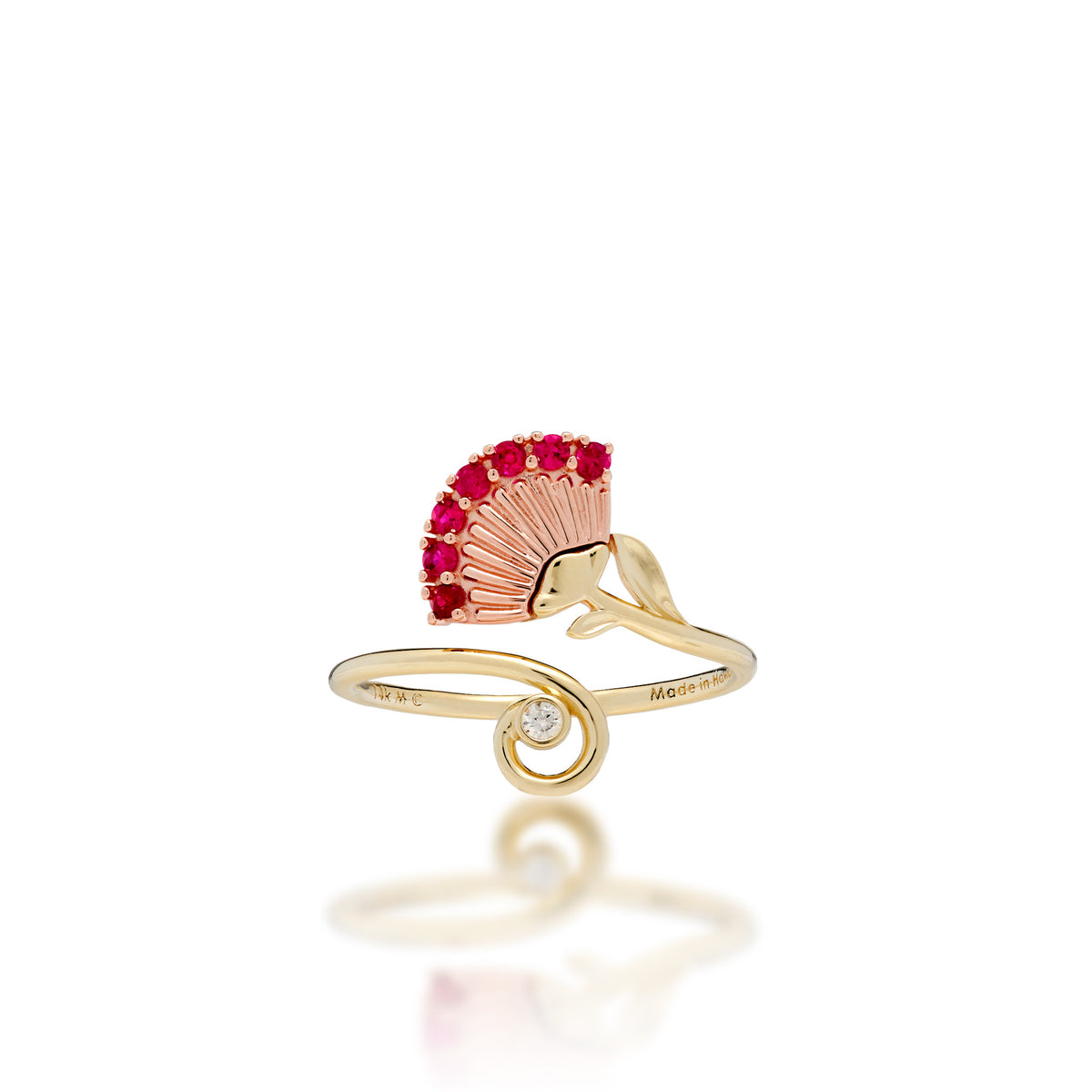 An ʻŌhiʻa Lehua Flower Ring with a 14k Rose gold flower set with red rubies and a high-polish 14k yellow gol dband with a curling end set with a diamond, shown on a white background