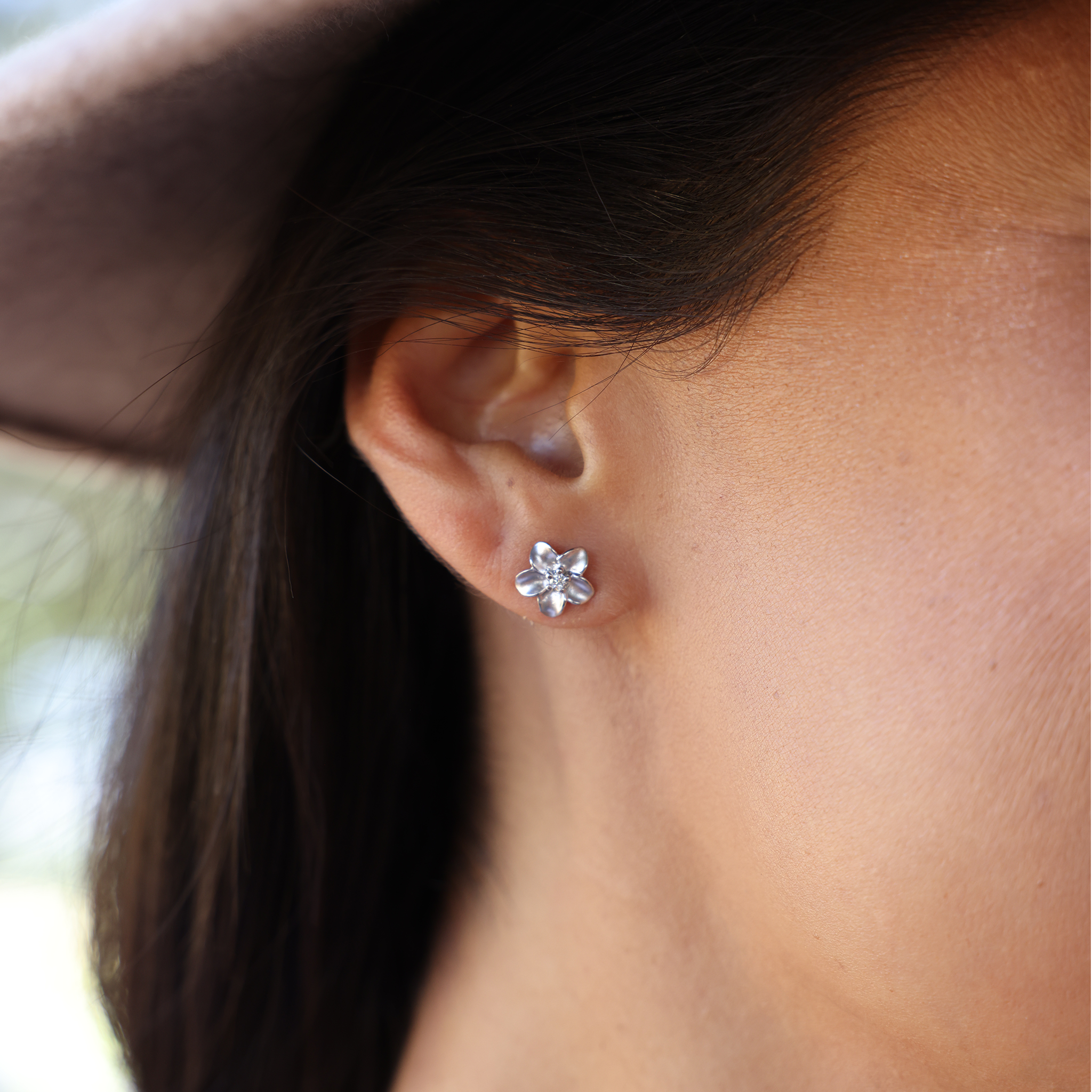 A woman wearing Plumeria Earrings in White Gold with Diamonds - 9mm-Maui Divers Jewelry
