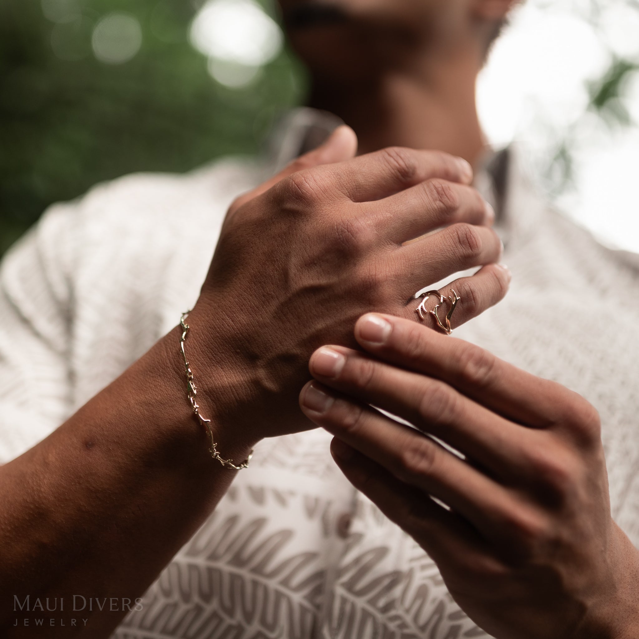 Heritage Coral Branch Ring and link Bracelet in Gold on a man blurred in the background