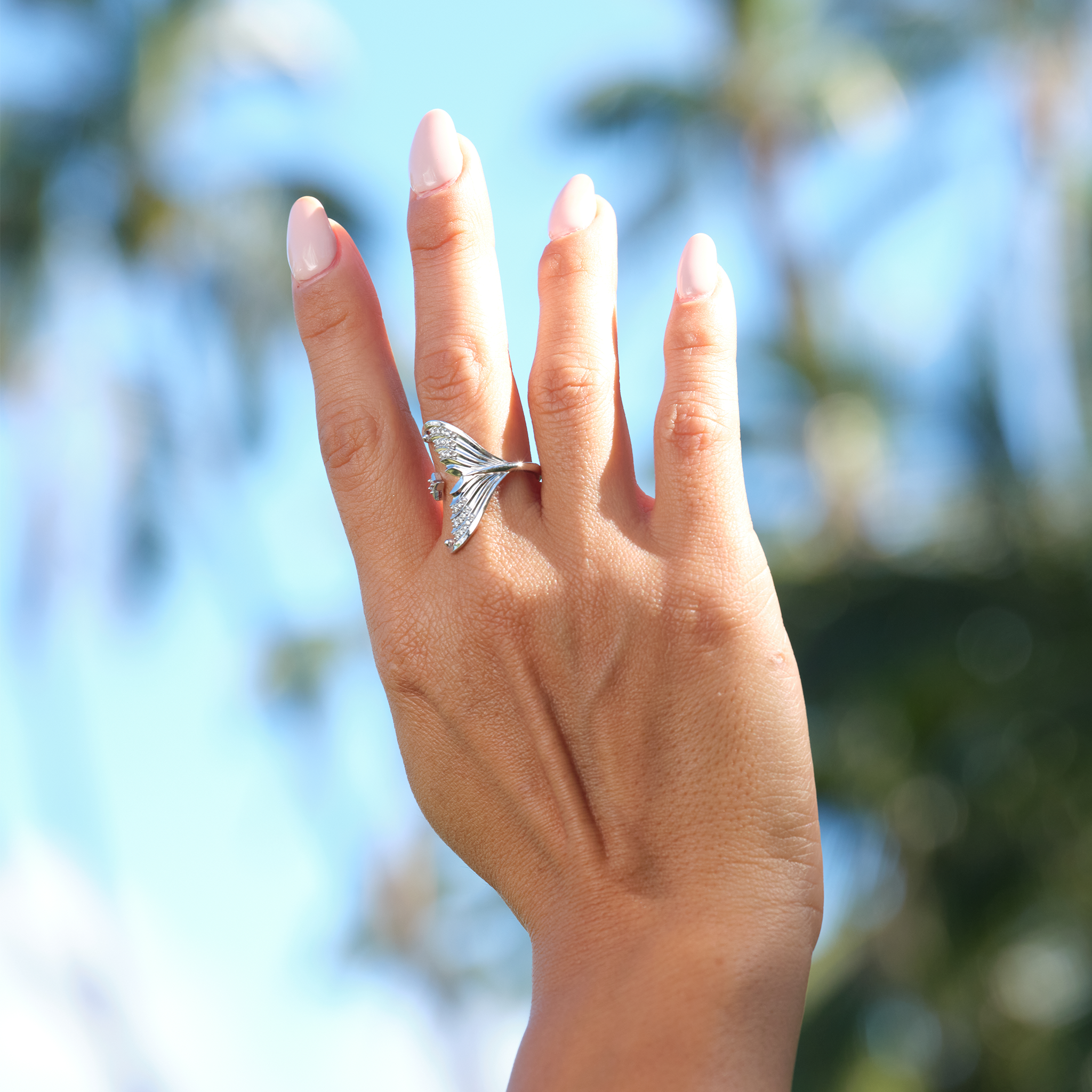 A woman's hand wearing a Moon Mermaid Ring in White Gold with Diamonds - Maui Divers Jewelry