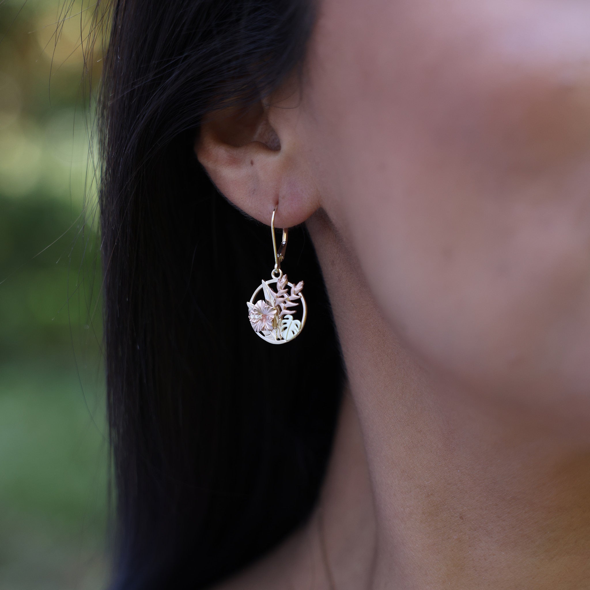 Close up of Hawaiian Gardens Hibiscus Earrings in Tri Color Gold with Diamonds on ear