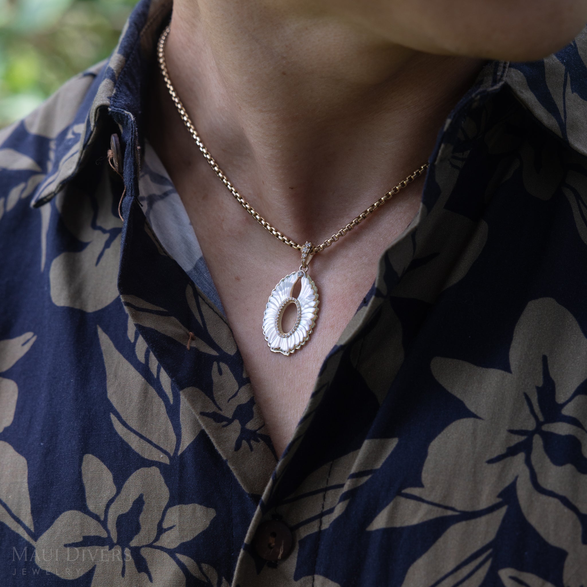 Close up of Pueo (Owl) Mother of Pearl Pendant in Gold with Diamonds on man