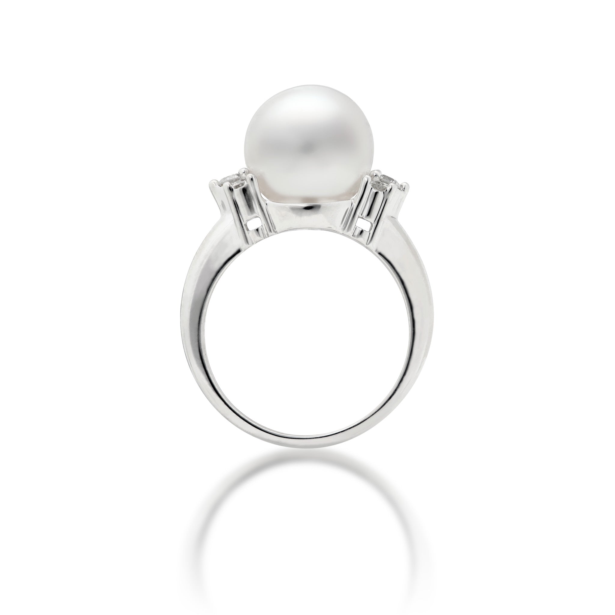 Side view of a 14k white gold ring featuring a large, lustrous South Sea White pearl as the center stone, accented by three diamonds on either side of the band, set against a clean white background with a soft reflection below.
