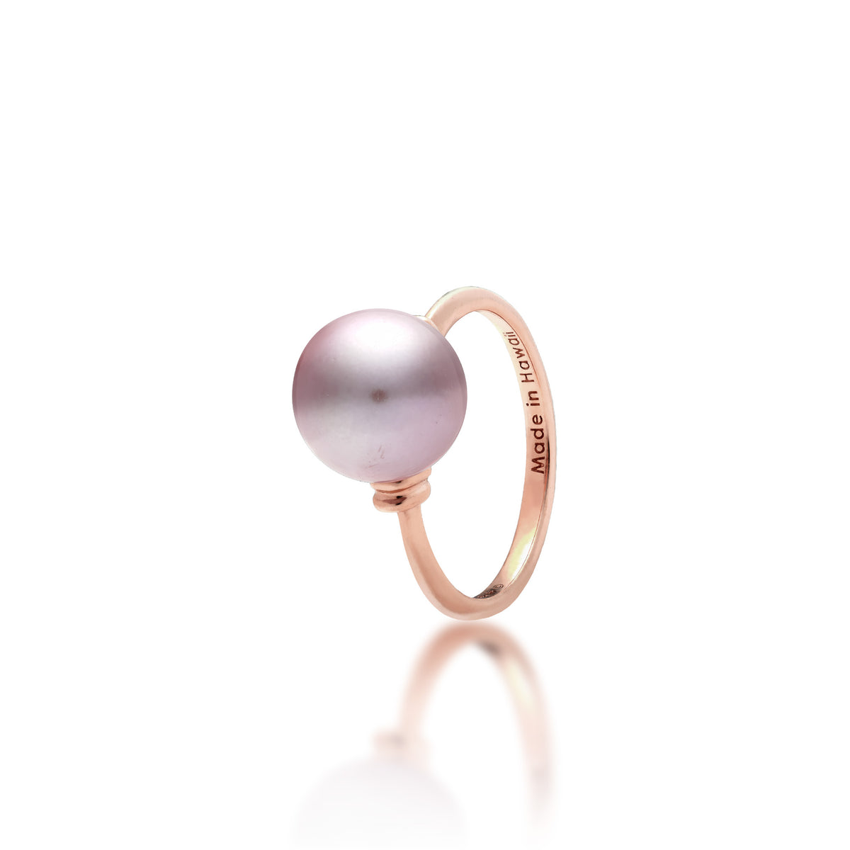 A 14k rose gold ring with a lilac freshwater pearl and raised divot accents in rose gold on each side  of the pearl, shown on a white background