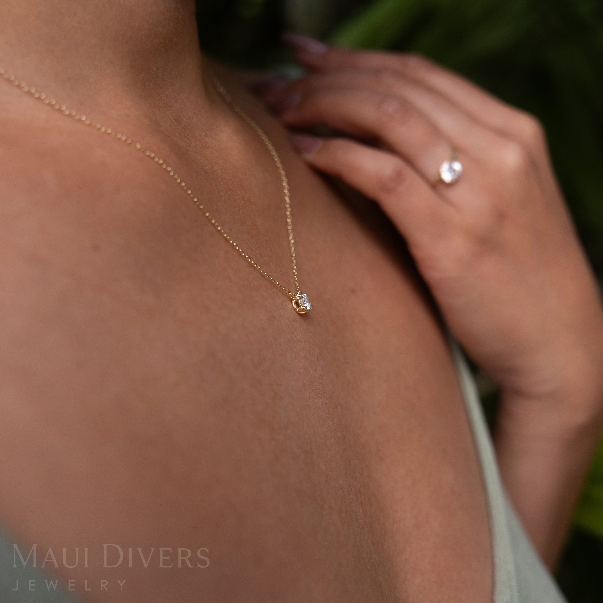 Close-up Sideview of an Adjustable Hidden Hawaiʻi Maile Necklace in 14k Yellow Gold with a Lab Grown Diamond Worn Around A Neck