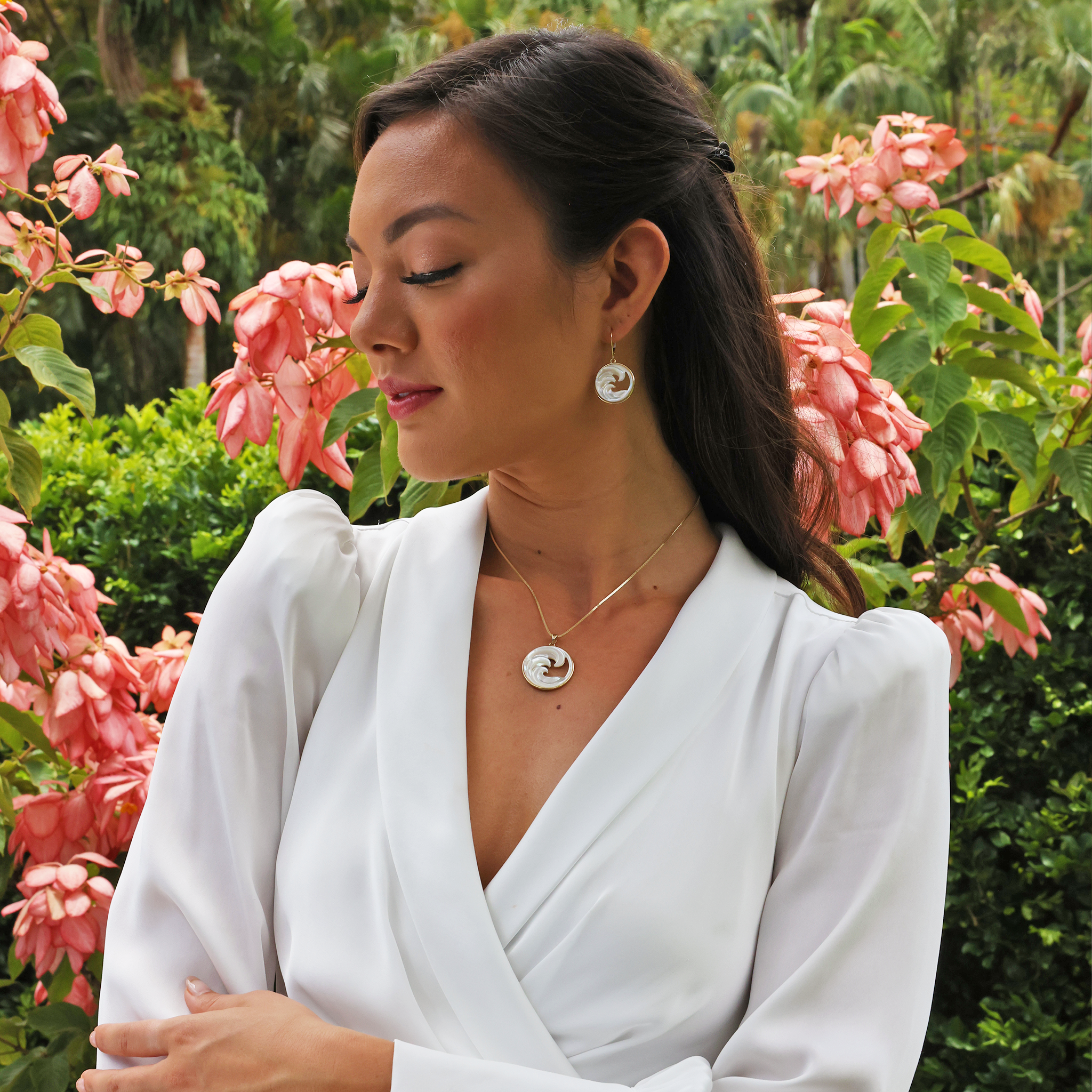 A woman wearing a Nalu Mother of Pearl Pendant in Gold - 27mm - Maui Divers Jewelry