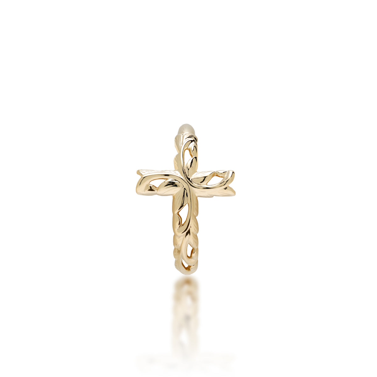 A delicate 14k yellow gold ring featuring a cross design with maile leaf and fern Old-English scrollwork, shown on a clean white background with a soft reflection below.