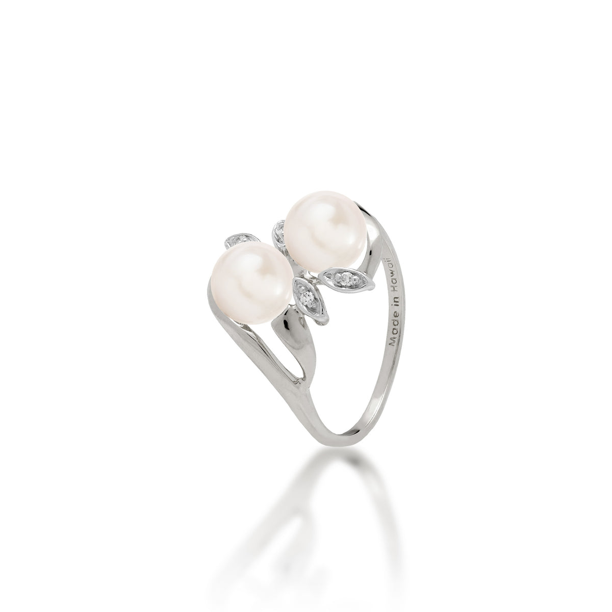 A 14k white gold ring with two white freshwater pearls and two diamond accent maile leaves on each side, shown on white background