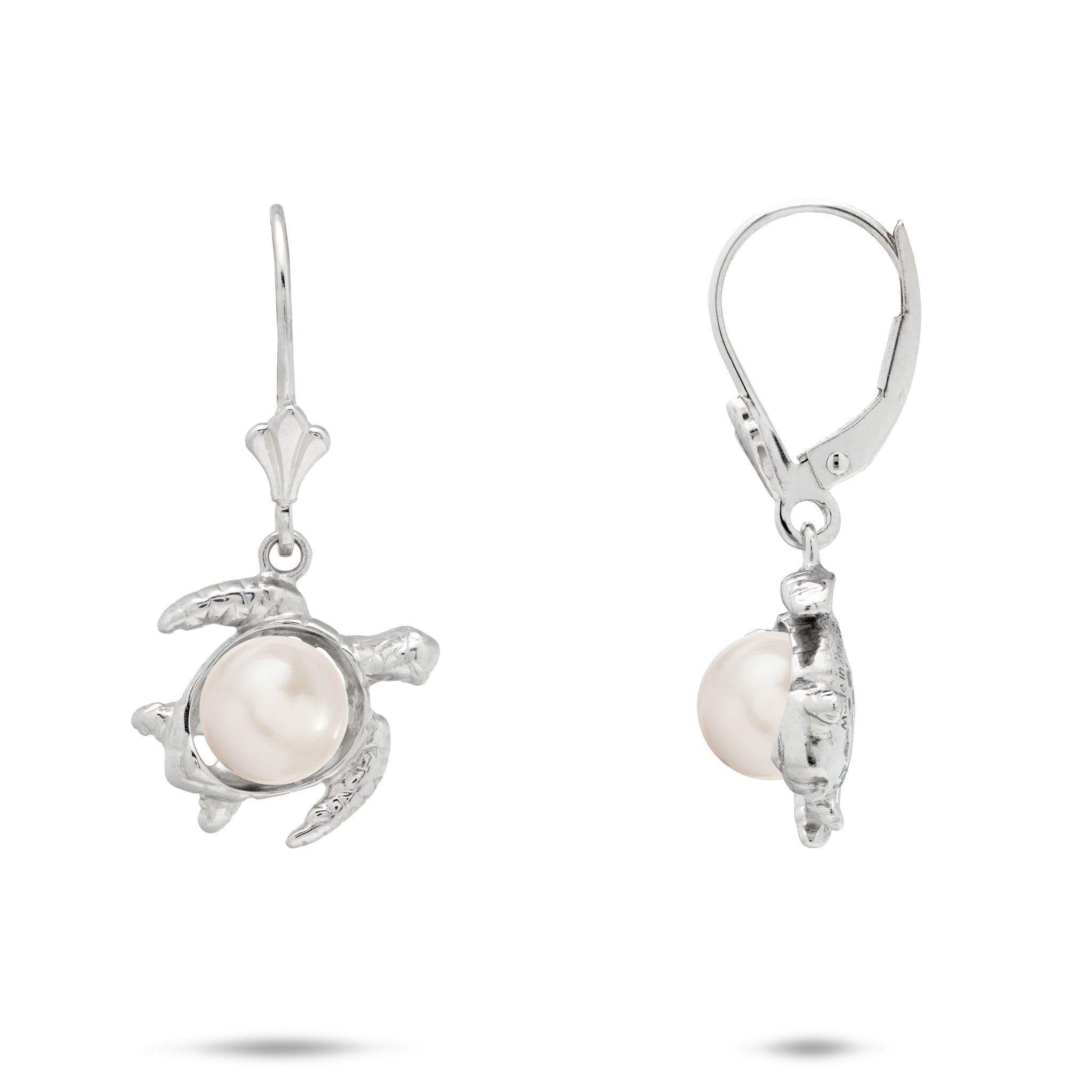 A pair of sterling silver earrings featuring a Hawaiian green sea turtle-shaped setting holding a round, white freshwater pearl, shown against a plain white background.