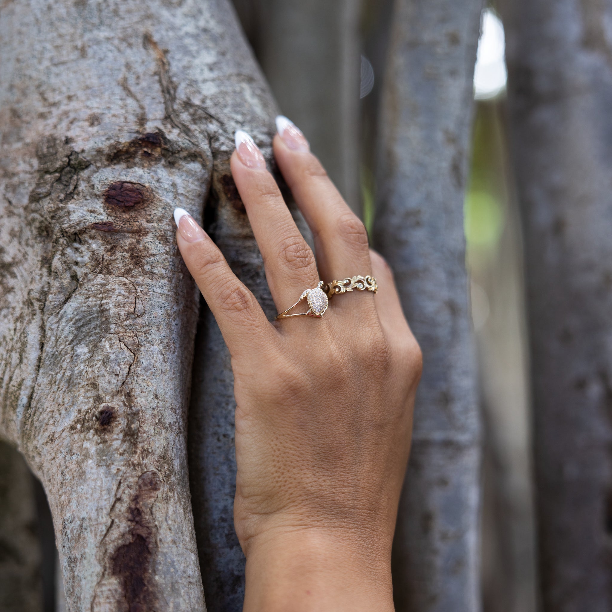 A woman's hand wearing a Living Heirloom Ring in Gold with Diamonds and a ring - Maui Divers Jewelry