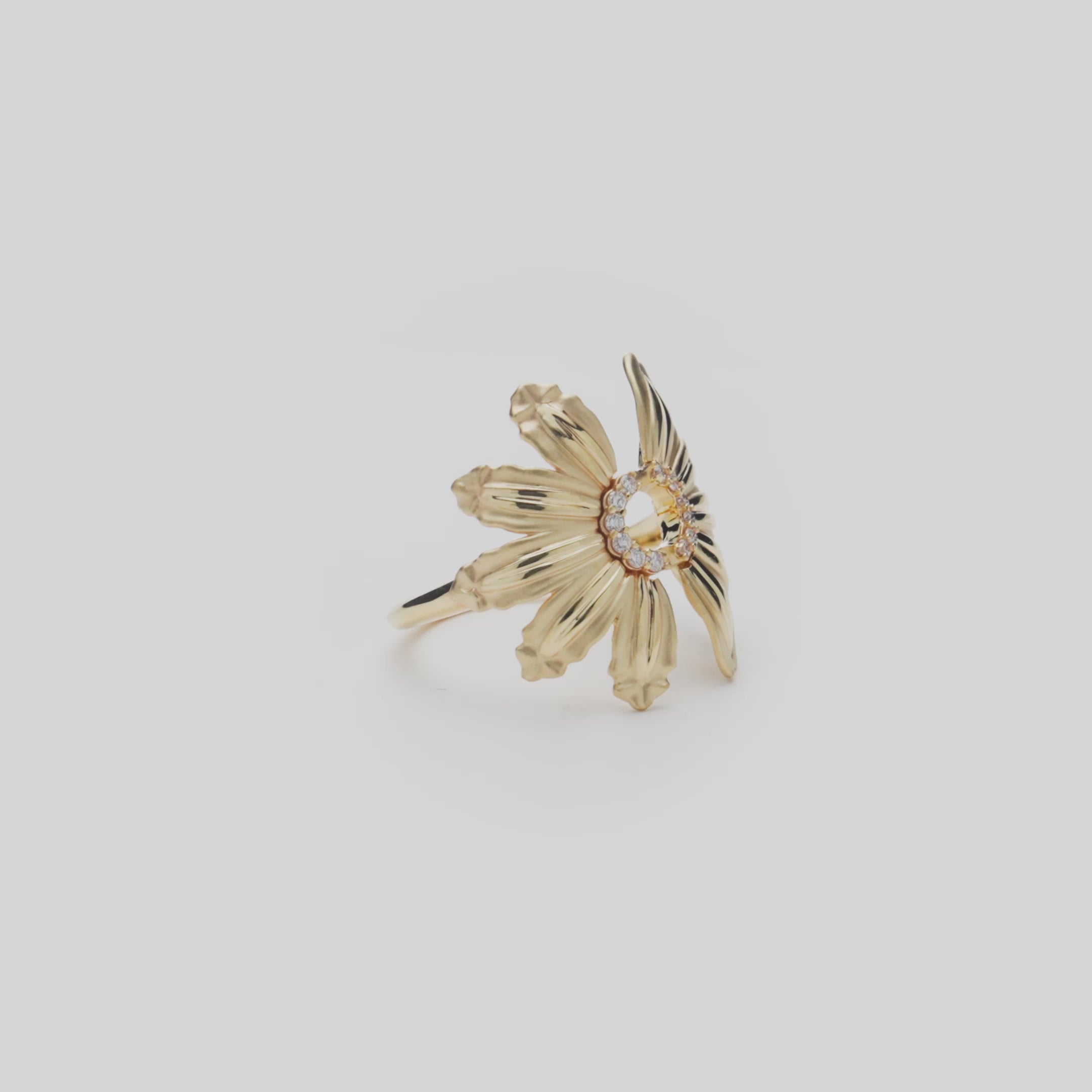 Beach & Mountain Naupaka Ring in Gold with Diamonds on a white turntable