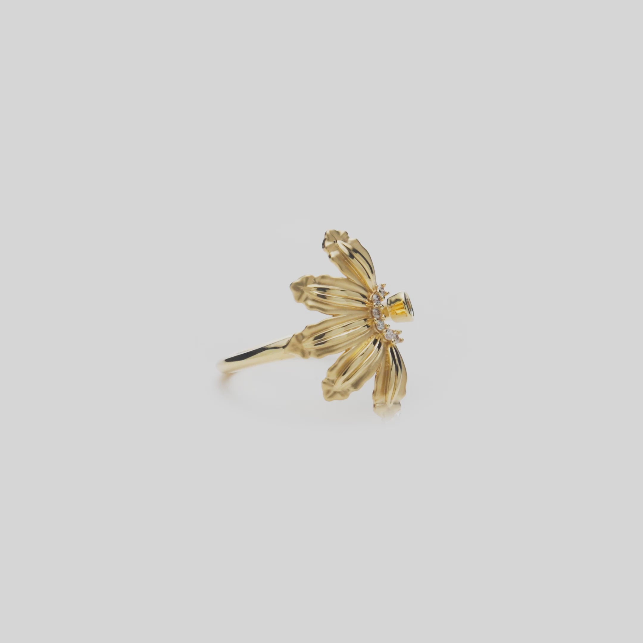 Mountain Naupaka Ring in Gold with Diamonds on a white turntable
