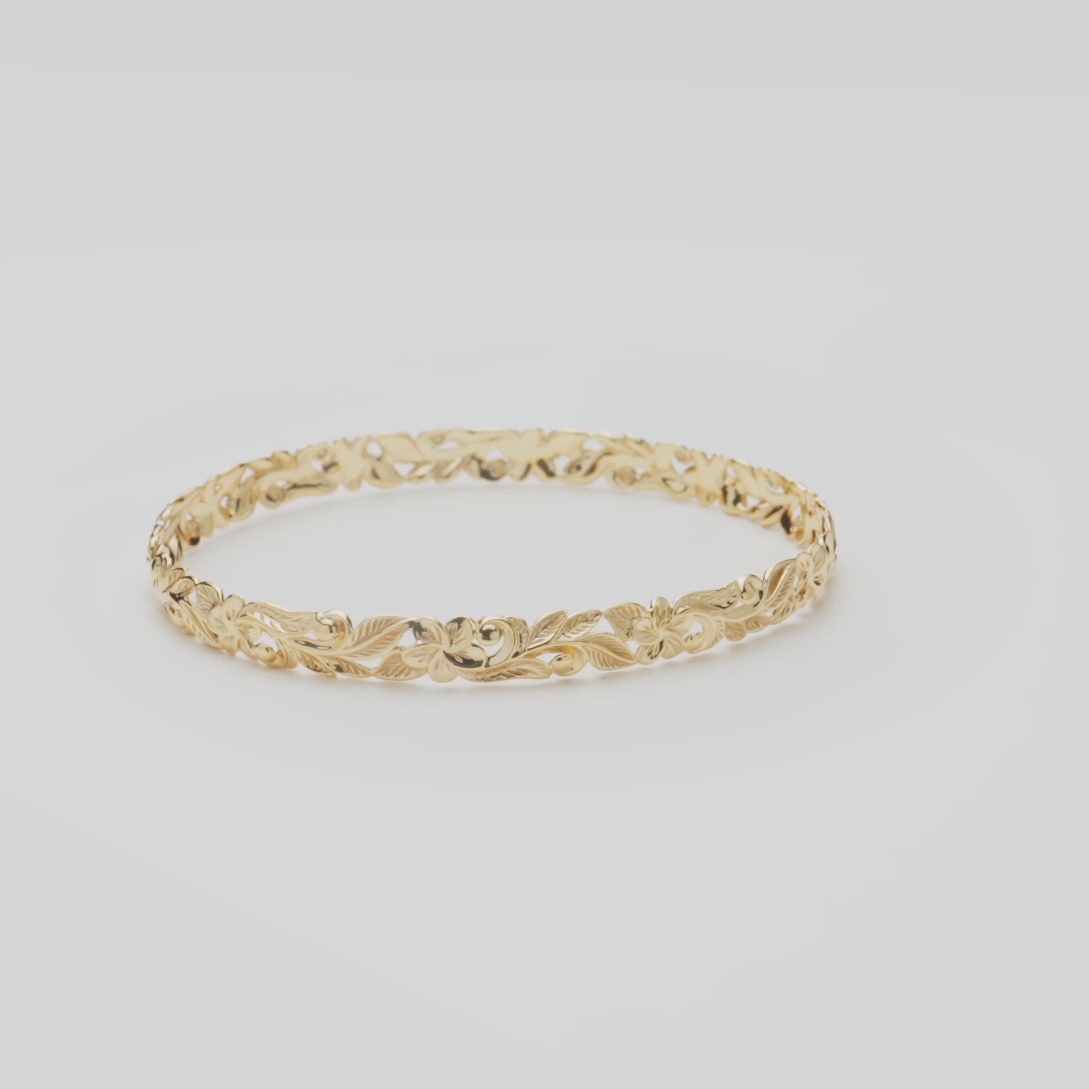 Hawaiian Heirloom Plumeria Bracelet in Gold on a white turntable
