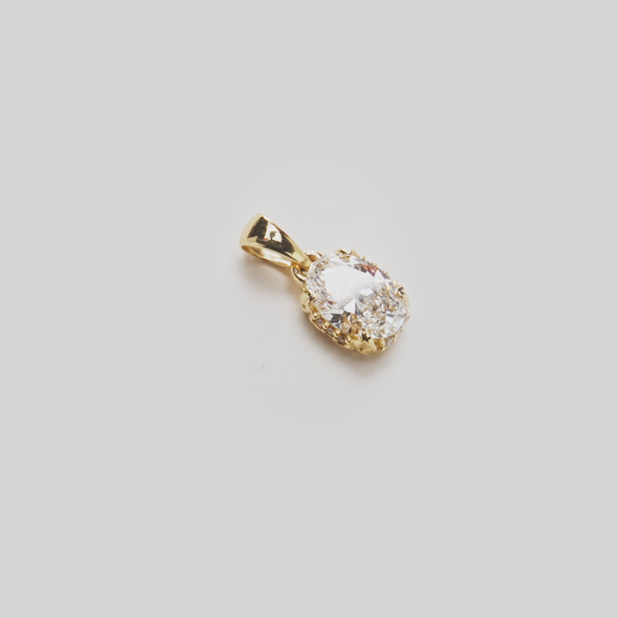 Close up video of the Hidden Hawaiʻi Maile Lab Grown Diamond Pendant in Gold on white turntable