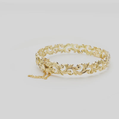 Living Heirloom Hinge Bracelet in 14k Yellow Gold on a white turn table