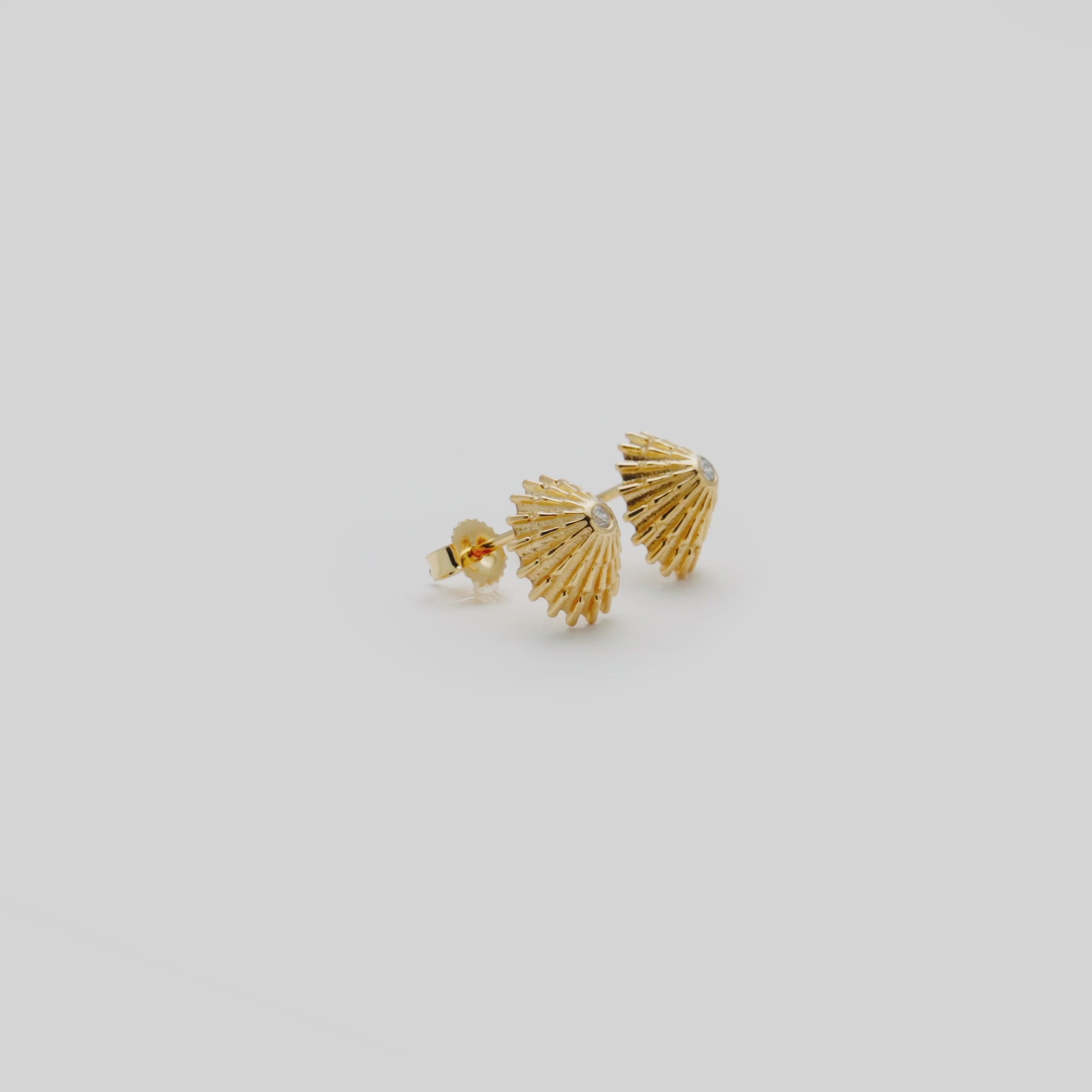 Video showcasing the 10mm ʻOpihi Earrings in Yellow Gold with Diamonds on a turn table