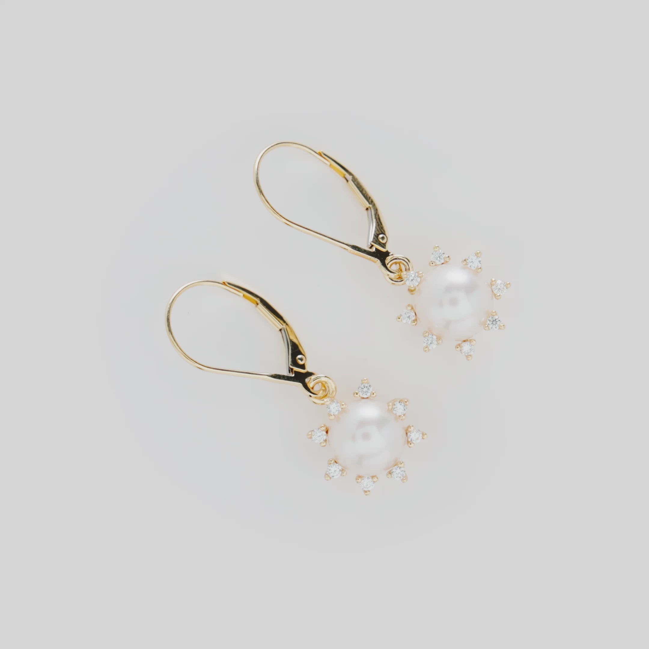 Video showcasing the Protea Akoya White Pearl Earrings in Gold with Diamonds on a turn table
